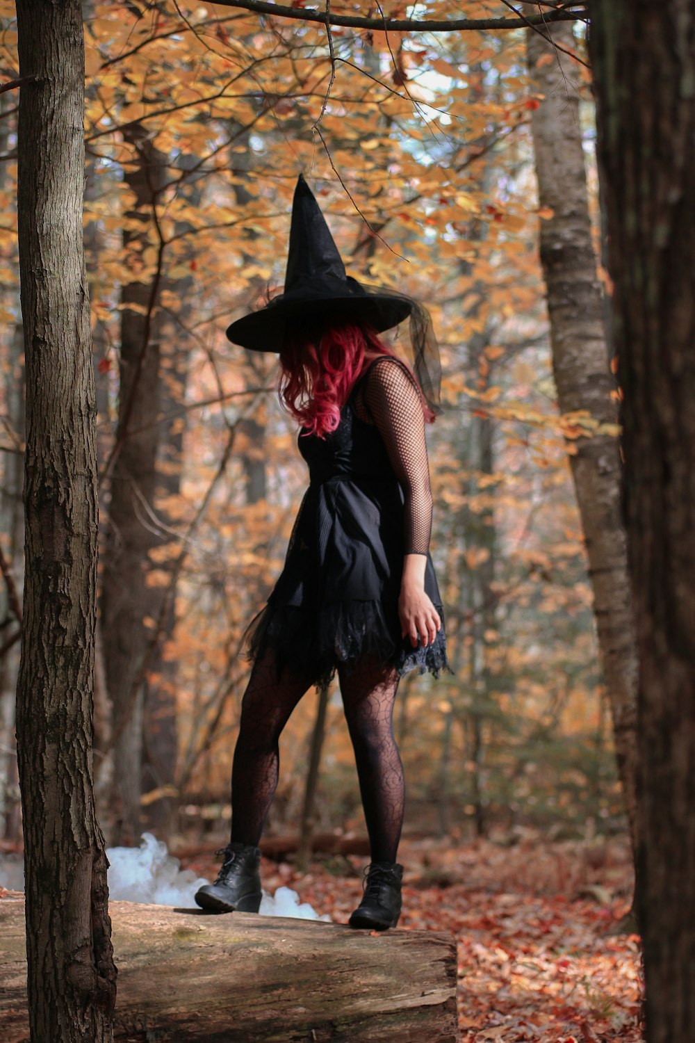 witch standing under trees