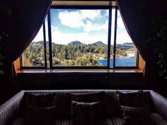 An elegant forest-view property showcasing expansive windows and natural light.