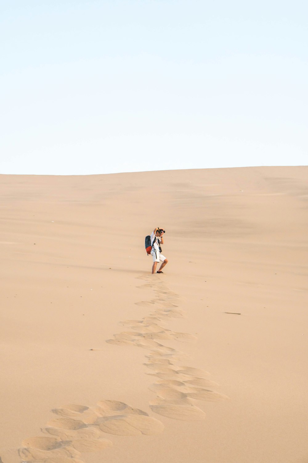 man walking on brown filed