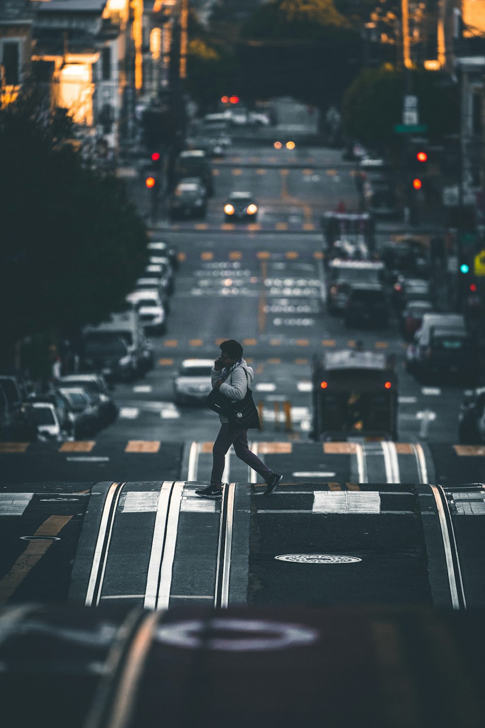 man crossing the road during day
