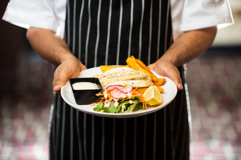 A chef presenting a finished plate