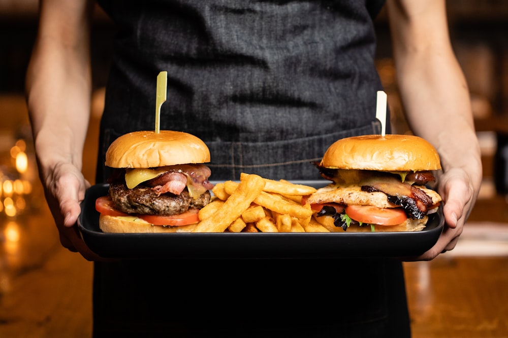 hamburgers and fries on tray