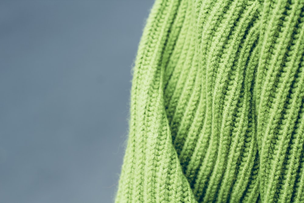 a close up of a green knitted sweater