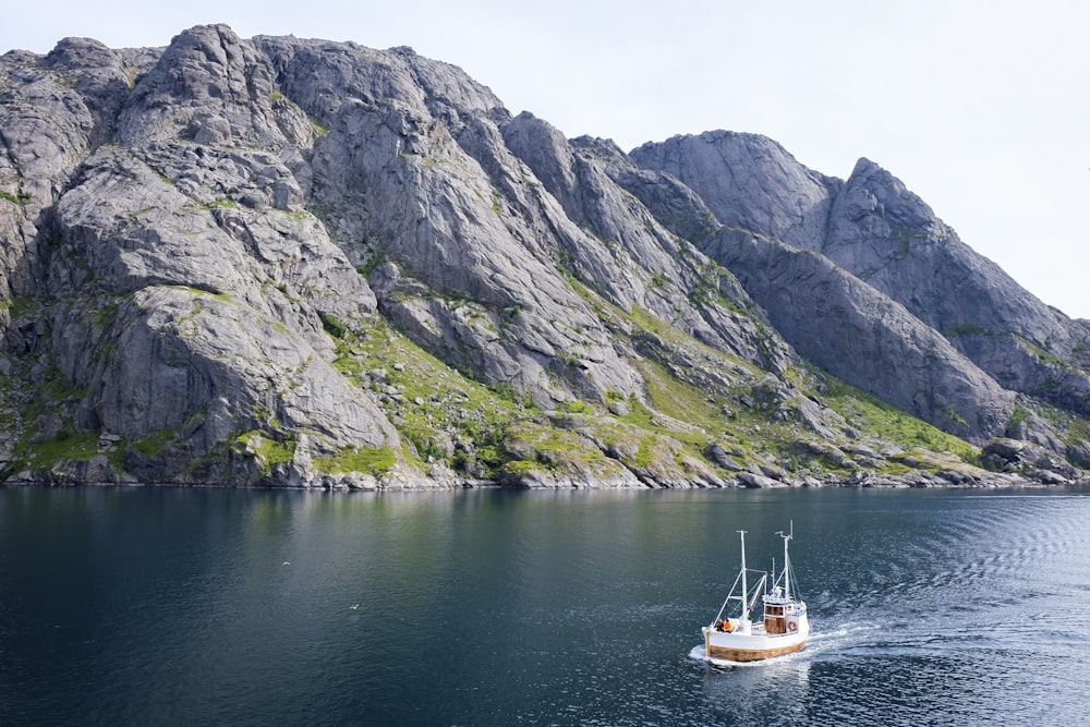 white and brown boat on body of water during daytime