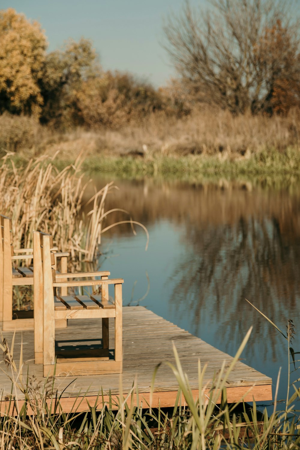 chairs on dock near lake