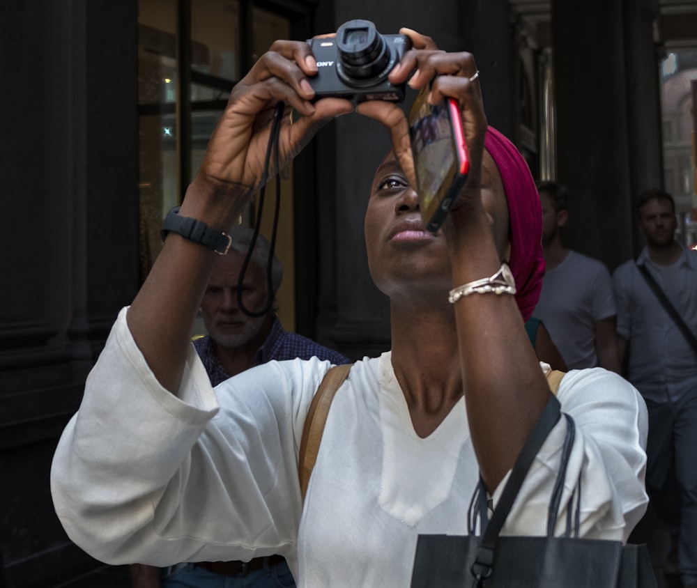 woman looking at point-and-shoot camera