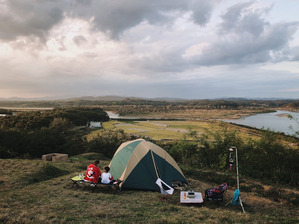 people sitting beside tent