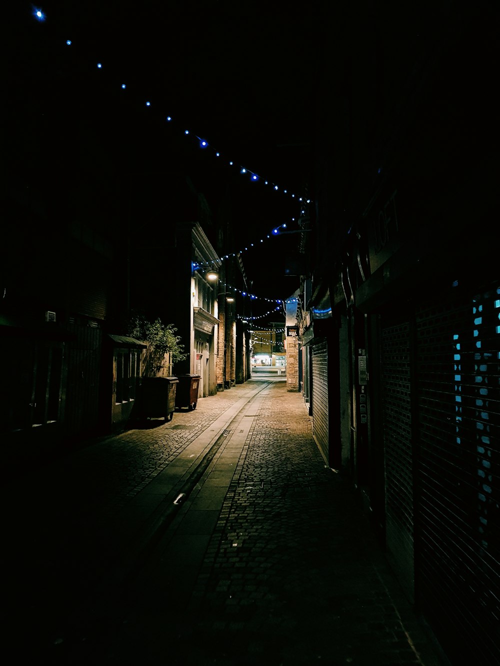 empty alley between houses and stores at night