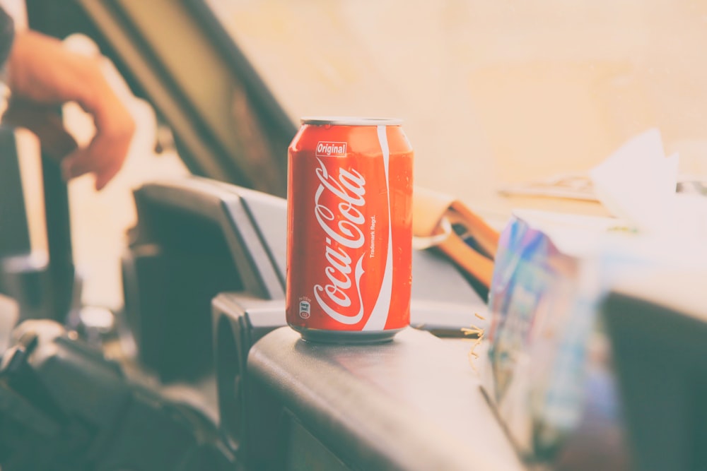 Coca-Cola soda can on car dashboard
