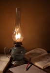 gray oil lamp beside book