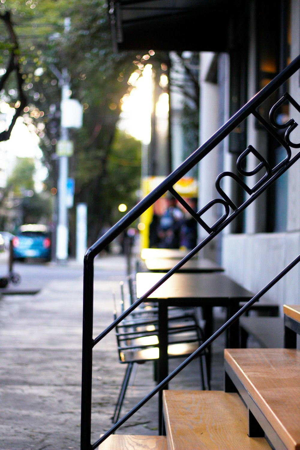 shallow focus photo of black stair rail