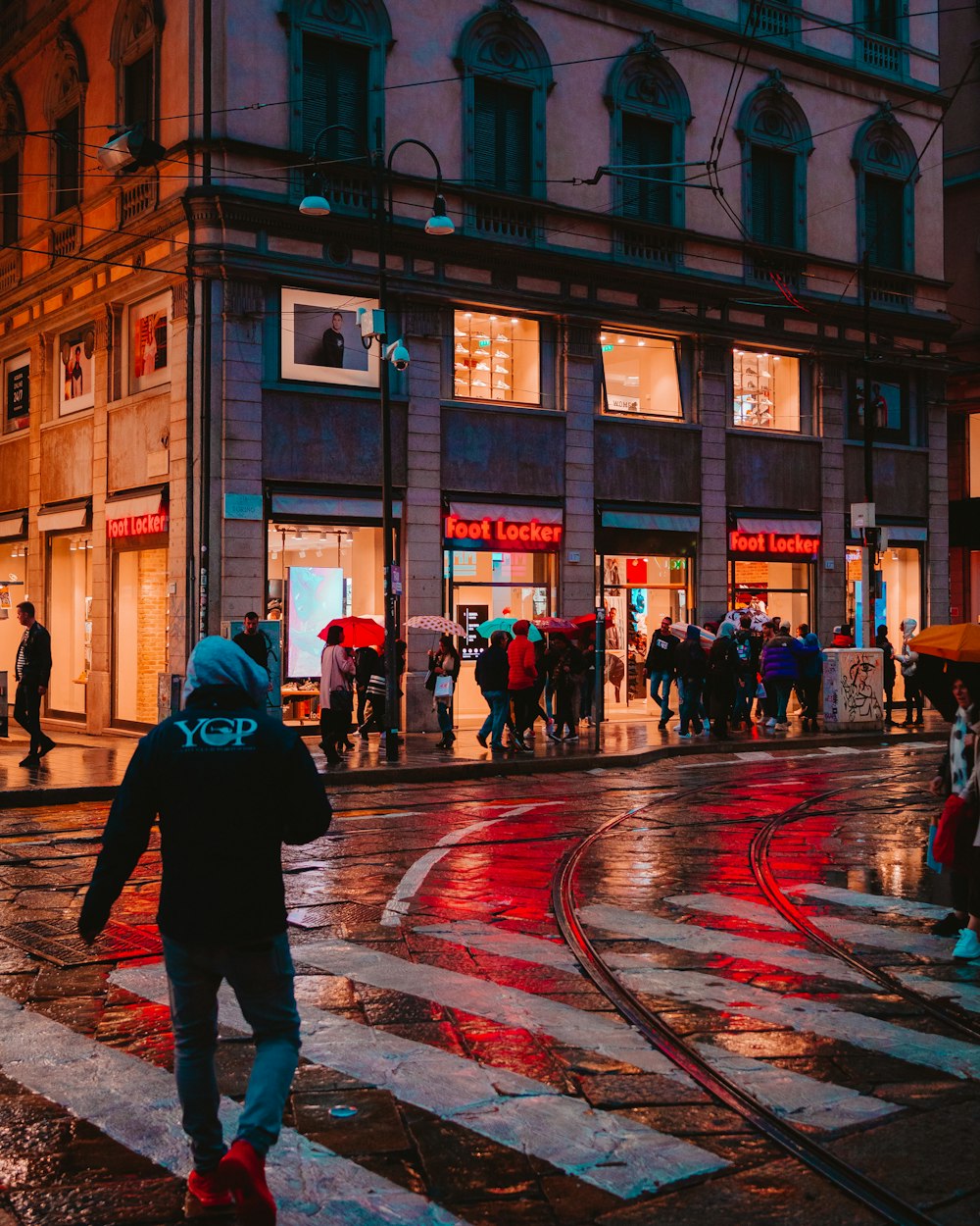 people walk on the street near Foot Locker store