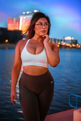 woman wearing white sports bra and brown leggings