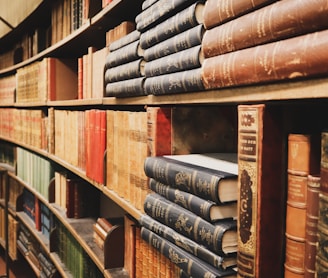 assorted-color books on bookcase