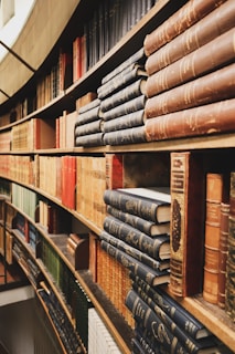 assorted-color books on bookcase