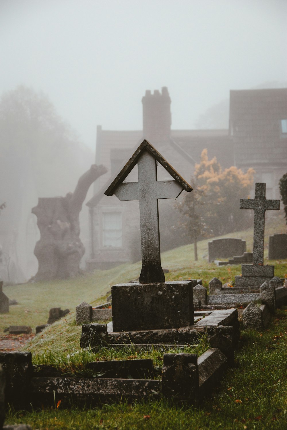 view of gravestones at cemetery with fog