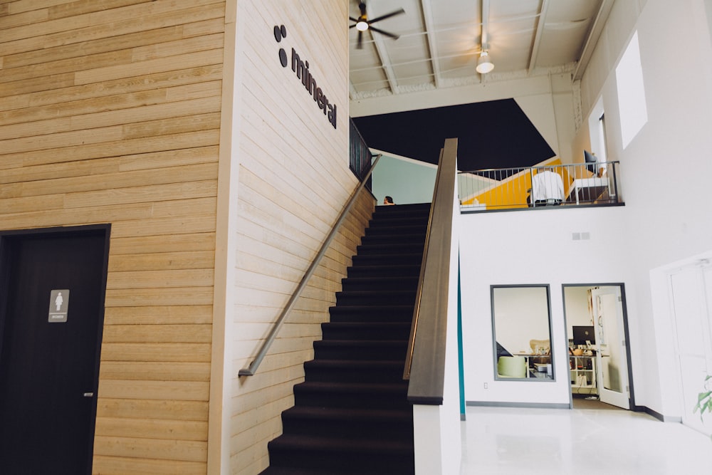 black staircase and brown wooden wall