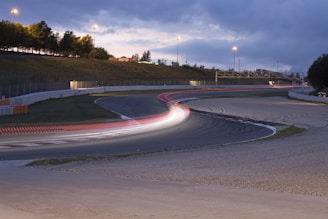 Wide shot of the foam track with racers navigating a sharp turn during a packed Wednesday night session
