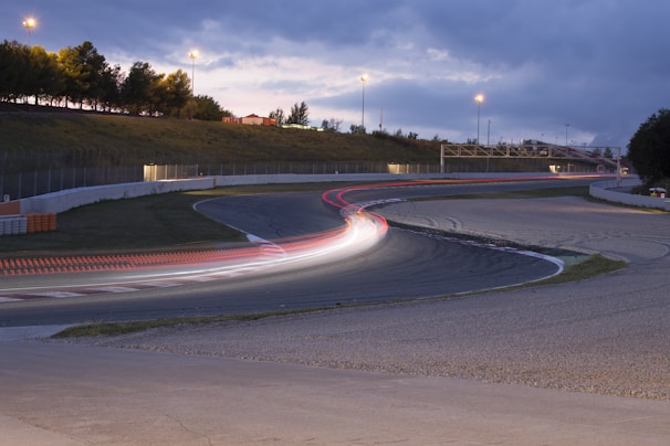 Wide shot of the foam track with racers navigating a sharp turn during a packed Wednesday night session
