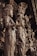 Intricately carved wooden statues with detailed, ornate features depicting human-like figures adorned in traditional attire. The sculptures present a sense of grandeur and artistic craftsmanship, showcasing detailed facial expressions and elaborate headdresses.