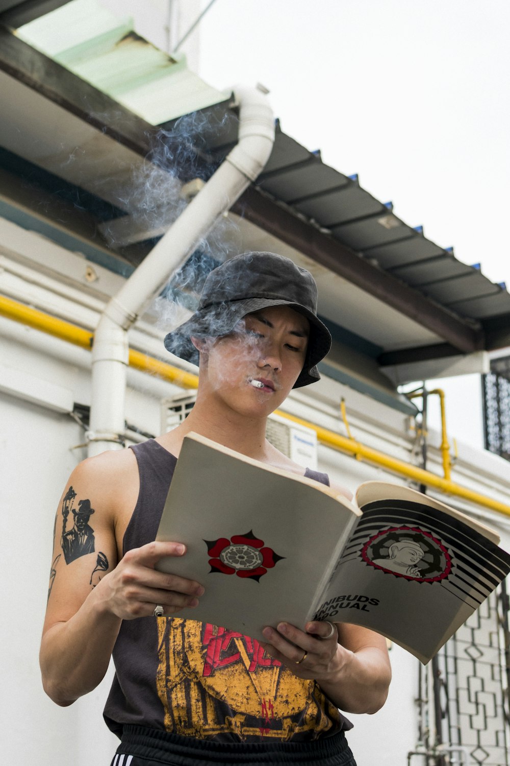 smoking man holding book