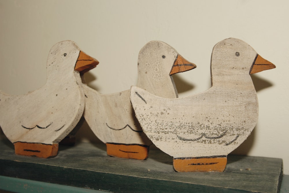 beige-white wooden duck figures