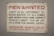 A vintage sign with bold red and black lettering on a white background. The text advertises job openings for first-class mechanics and helpers, with instructions to contact Charles Schmidt for an application. The bottom features the name of a shipbuilding and dry dock company located in Sturgeon Bay, Wisconsin.
