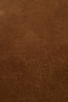 Close-up of wet blue leather texture showing fine grain and natural markings.