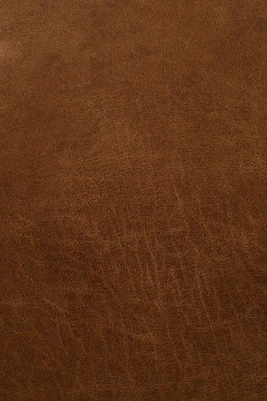 Close-up of rich, dark brown finished leather with visible natural grain texture.