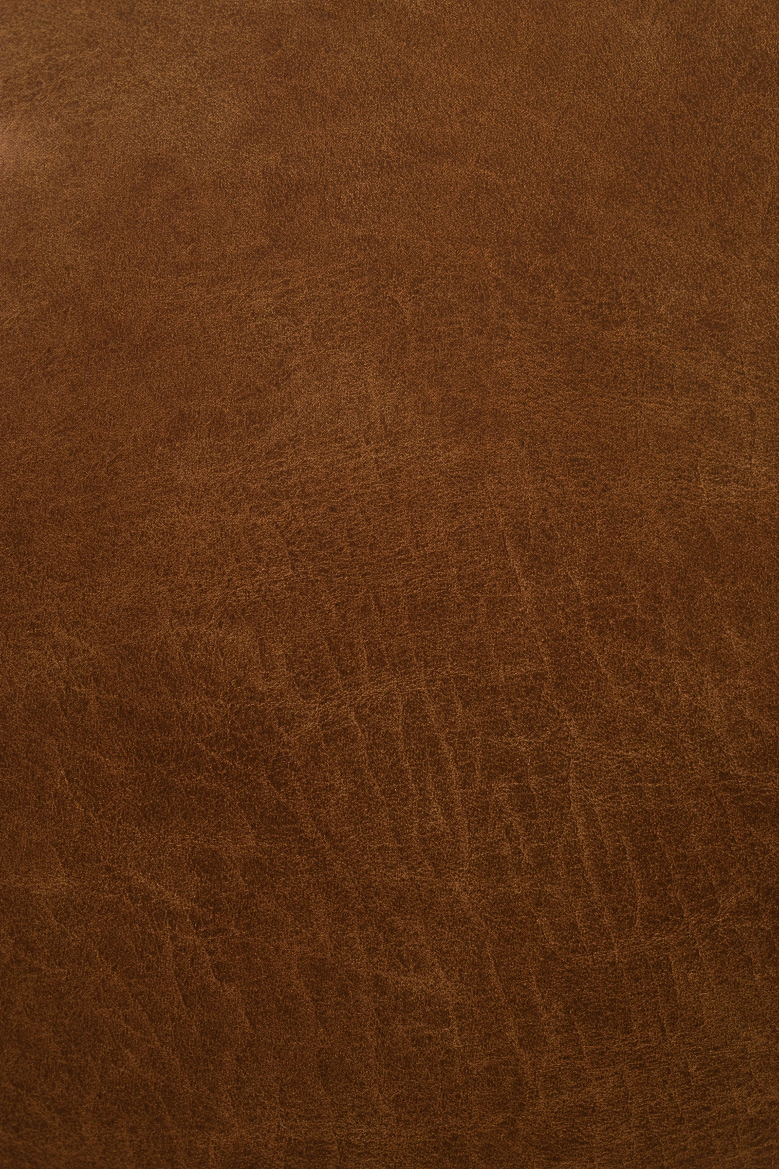 Vegetable-tanned saddle leather, the surface used to line drawers, wrap pulls, and overlay shelving