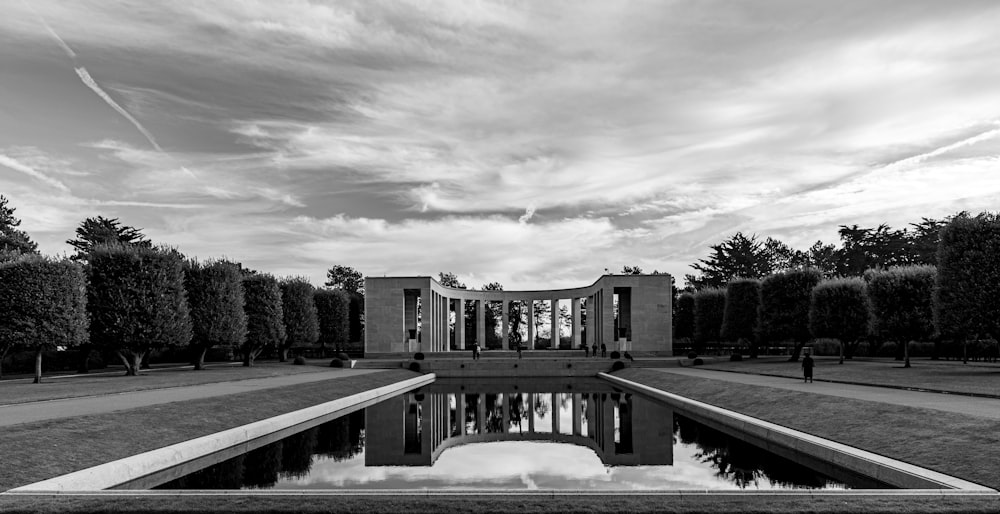 grayscale photography of building surrounded with trees