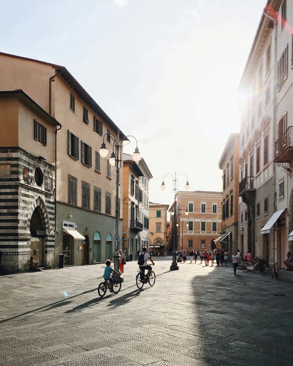 children riding bicycle on road