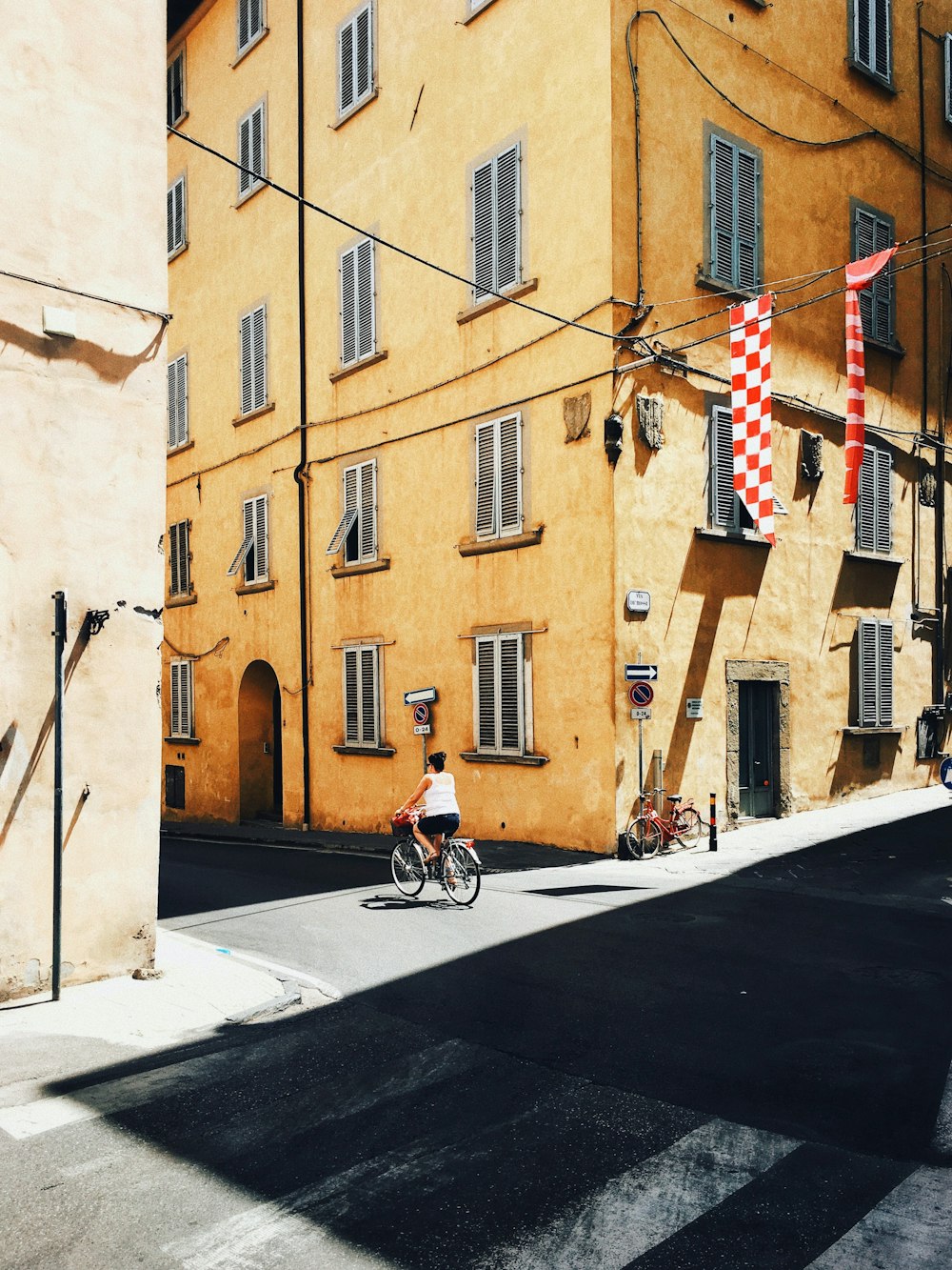 person riding bicycle near building