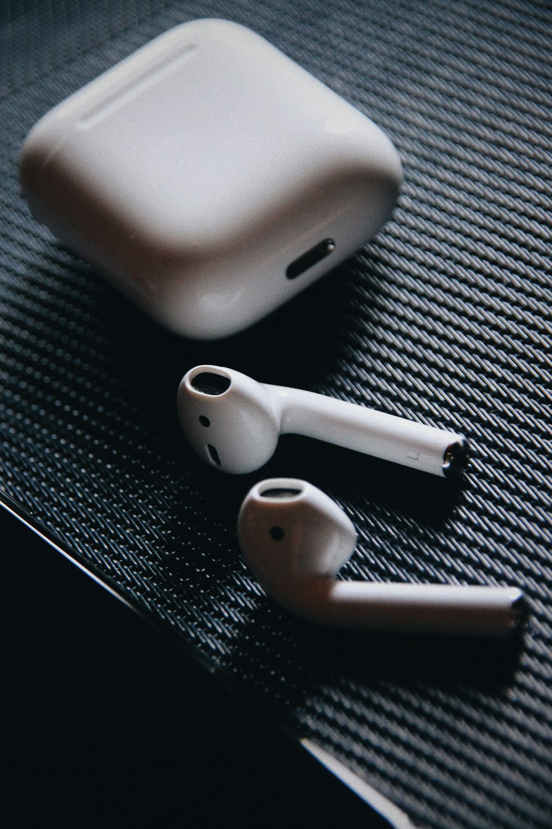 white Apple AirPods with charging case