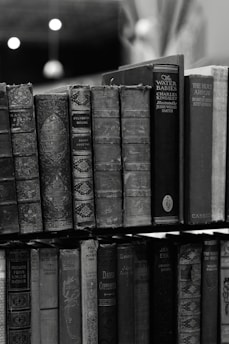 a stack of books sitting on top of a shelf