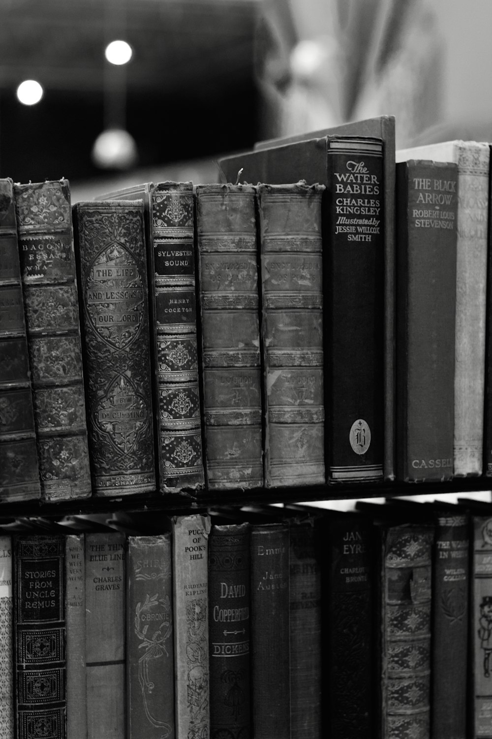 a stack of books sitting on top of a shelf