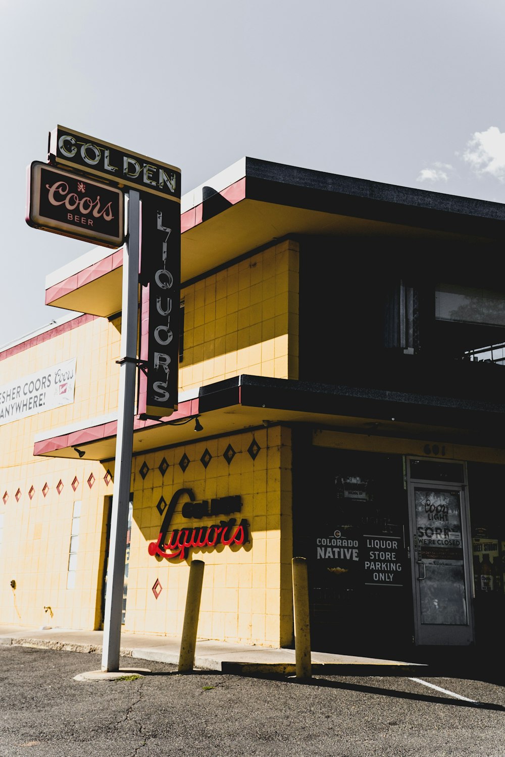 a yellow building with a street sign in front of it