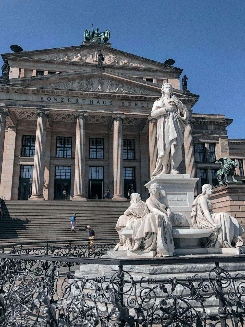 a large building with a statue in front of it