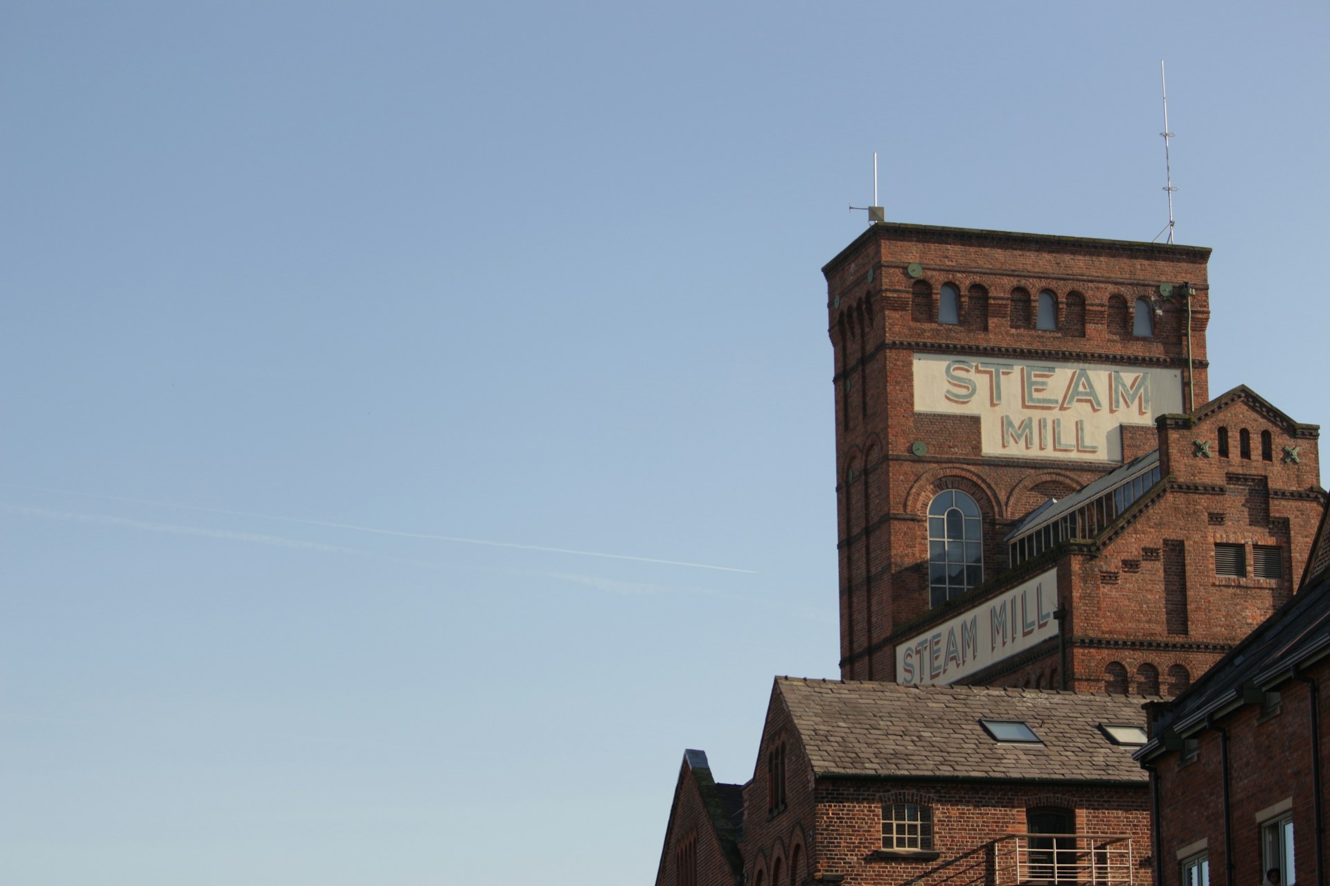 a tall brick building with a steeple on top