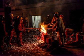 a group of people standing around a fire