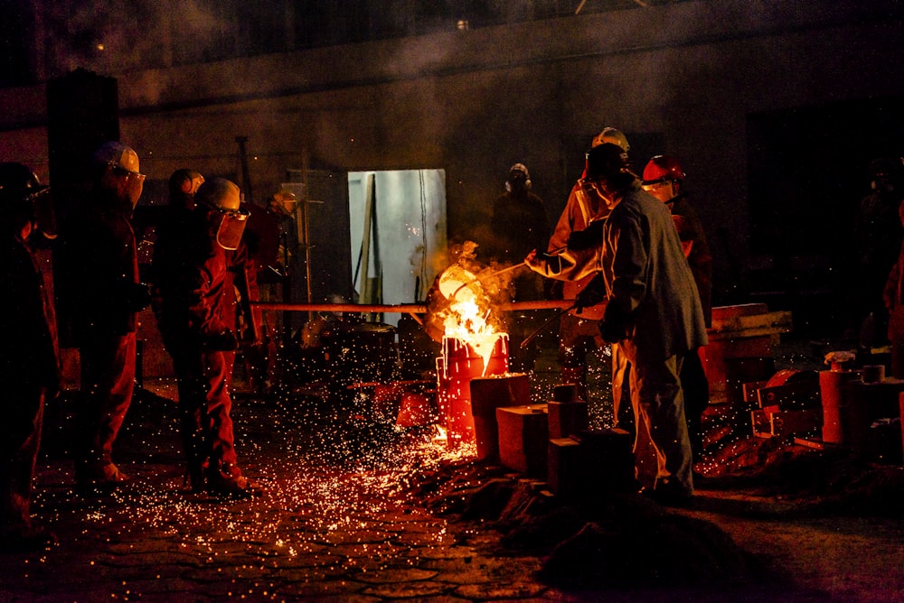 a group of people standing around a fire