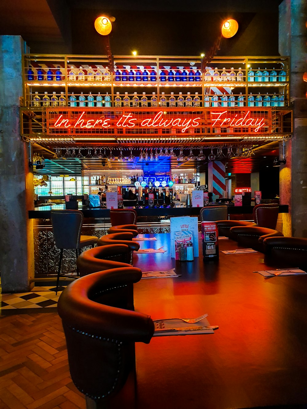 a bar with a lot of bottles on the ceiling