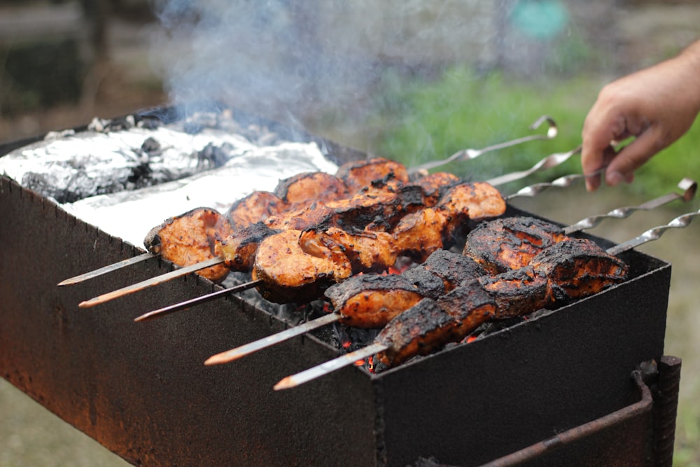 a person is cooking food on a grill