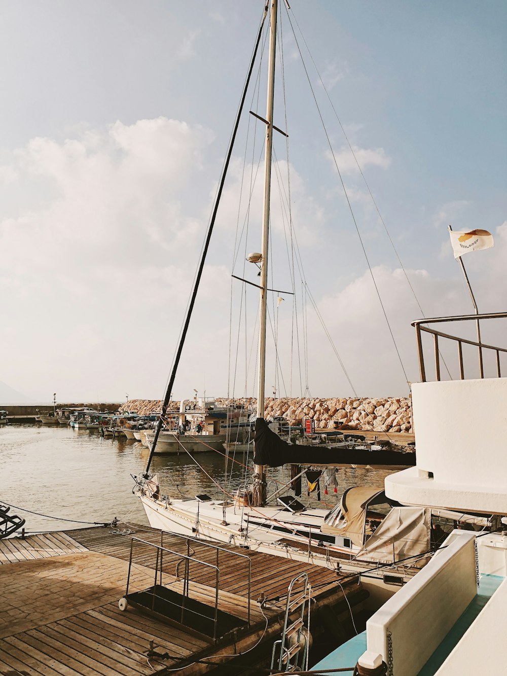 a sailboat docked at a dock with other boats