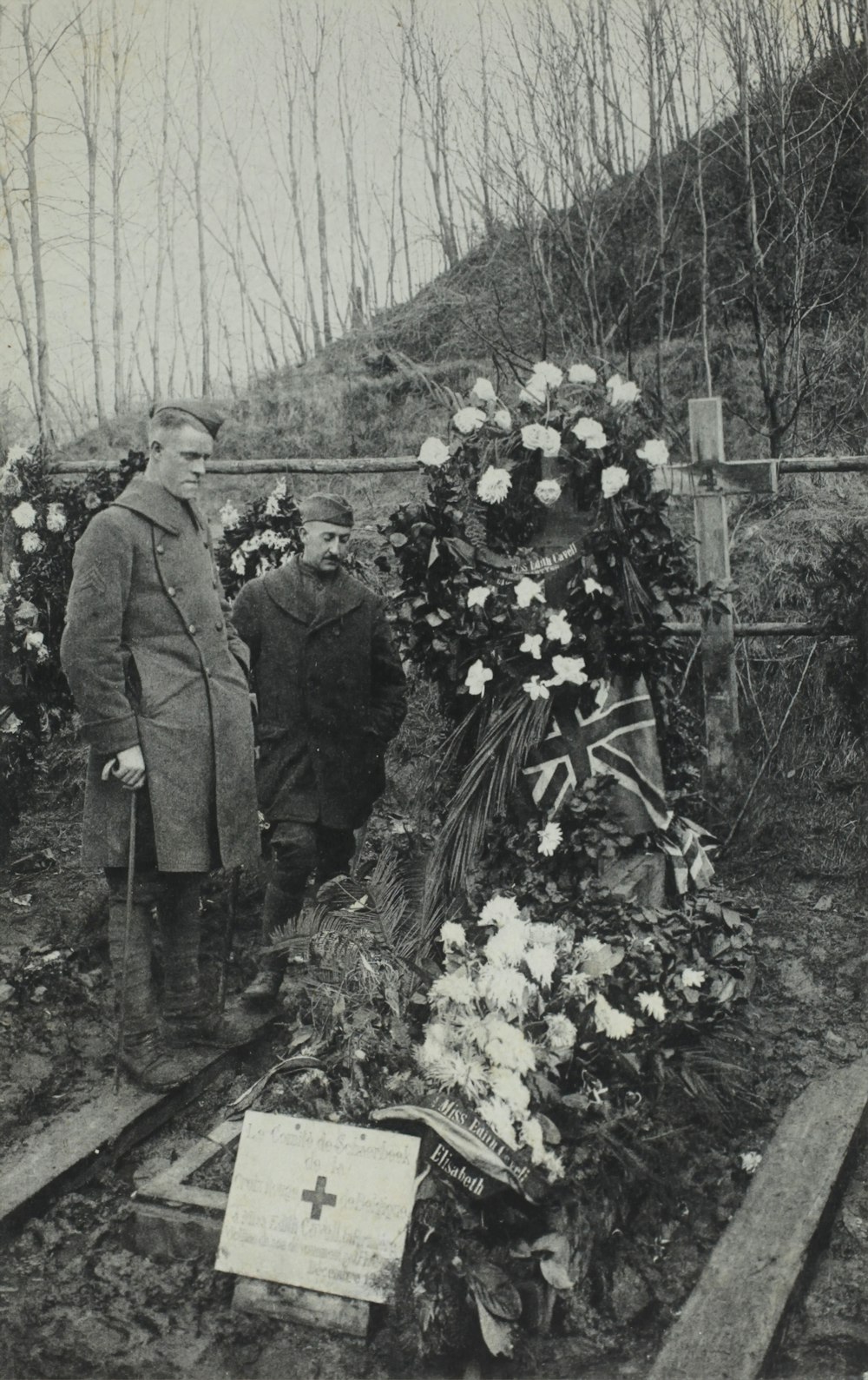 man standing beside grave