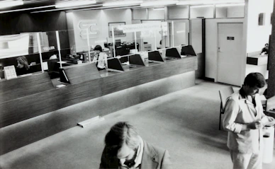 A close-up of hands opening a new bank account with a bank representative.