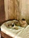 Close-up of traditional Moroccan babouches in warm earthy tones on a rustic wooden surface.