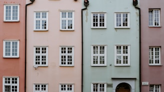 a row of different colored buildings with windows