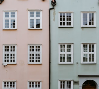 a row of different colored buildings with windows