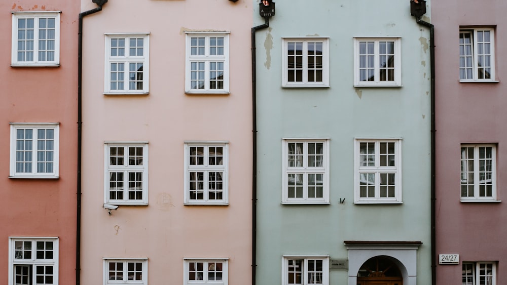 a row of different colored buildings with windows